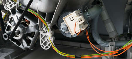 close-up of the internal structure of the washing machine, engine and electrical wiring with contact group, repairの写真素材