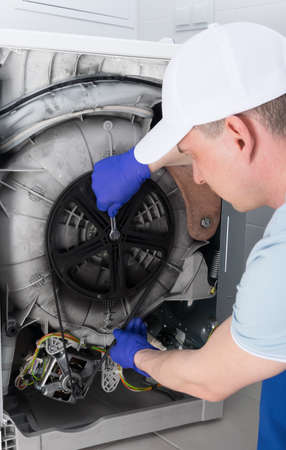 the process of repairing a washing machine, by a master, under warrantyの写真素材
