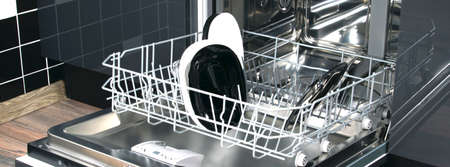 close-up of a dishwasher with plates on the background of a home kitchenの写真素材