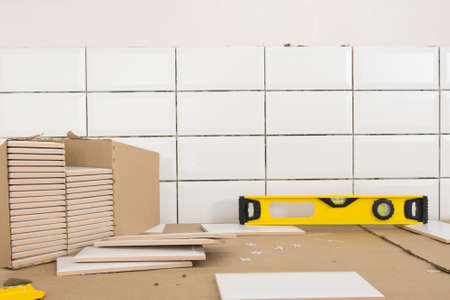 concept of finishing work in the apartment, box with wall tiles and tool - levelの写真素材
