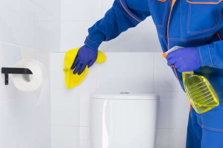 disinfection of surfaces in the toilet room by the cleaning service, close-upの写真素材