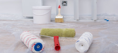 close-up of building materials, against a white wall, paint rollers, bucket and brushの写真素材