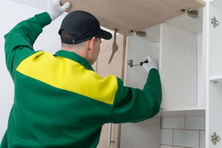 professional furniture assembler, installs door opening and closing systemの写真素材