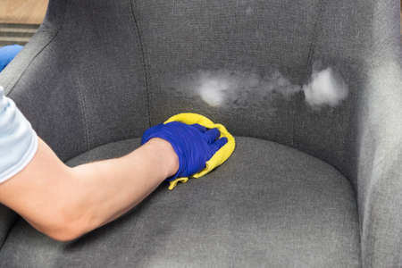 disinfection and washing of an upholstered chair, close-upの写真素材