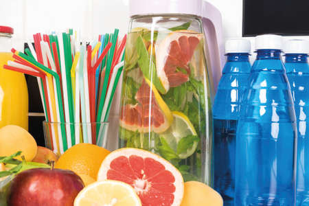 in the kitchen a set for fresh fruit lemonade. Ingredients lemon, mint, apples, orange, water, cocktail tubes, glass.の写真素材