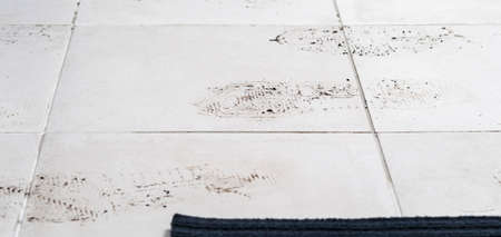 on the white tile floor, shoe marks after the street, backgroundの写真素材