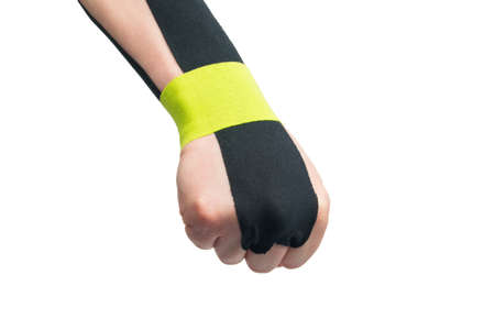 the   tape is pasted on the arm, to protect against injury during sports, on a white background, close-upの写真素材