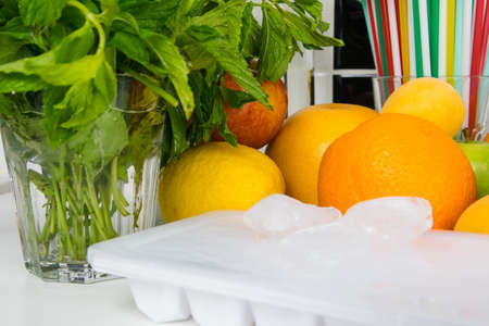 a set of fruits and herbs, for making drinks and ice in a tray, close-upの写真素材