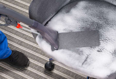 wet cleaning of the chair with a washing vacuum cleaner and thick foamの写真素材