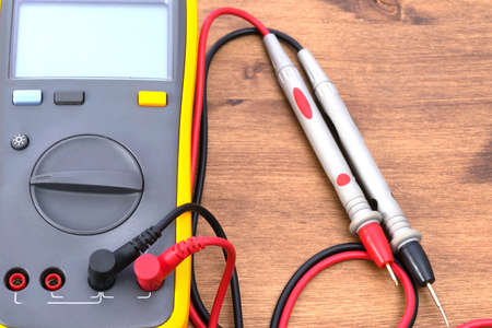 close-up of the electric tester on a wooden table, there is a place for an inscription on the screenの写真素材