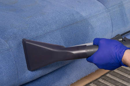 close-up of the cleaning vacuum cleaner brush, removes difficult dirt from the sofa textilesの写真素材