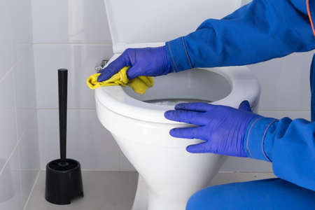 close-up of cleaning the toilet with a rag with disinfectantの写真素材