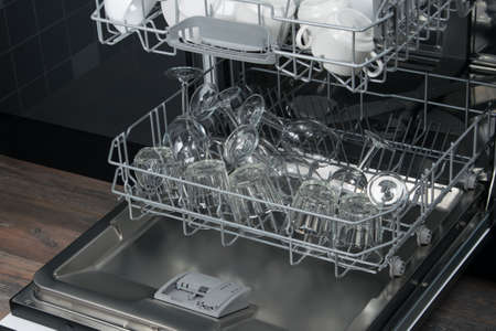clear glasses in the bottom grid of the dishwasher, after dryingの写真素材