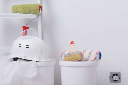 set of construction equipment and protective clothing, helmet and suit, on a white wallpaper backgroundの写真素材