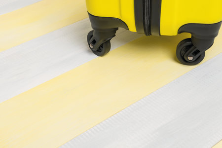 the lower part of the suitcase on the gray yellow floor boards, a place for your inscriptionの写真素材