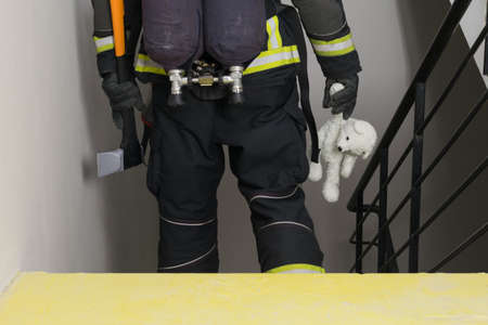 fireman holding plush toy, back viewの写真素材