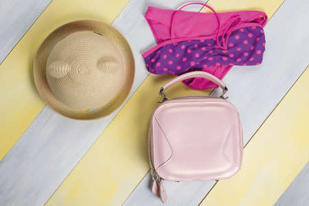 swimsuit, hat and handbag on a gray-yellow backgroundの写真素材
