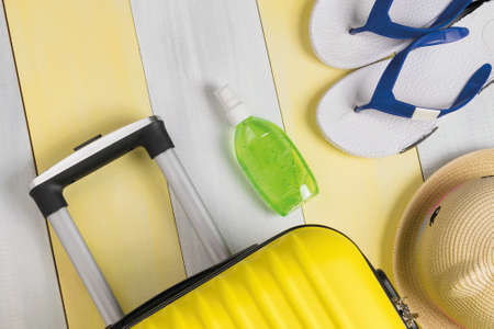beach set of things on a yellow-gray background with a suitcaseの写真素材