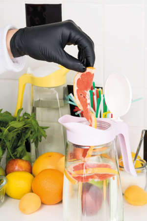 cooking refreshing lemonade from fruits and citrus fruits, front view, close-upの写真素材