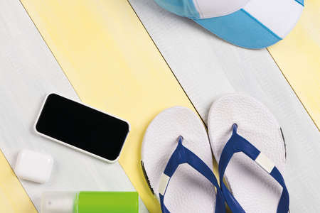 items for relaxing on the beach and sun protection products lie on a gray-yellow backgroundの写真素材