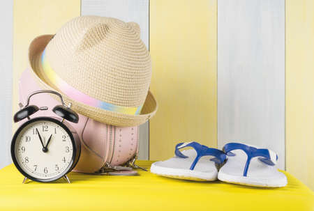 there are things and accessories for a beach holiday on a yellow suitcase, vacation time in warm...