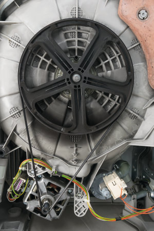large wheel with a belt from the motor for rotating the drum of the washing machineの写真素材
