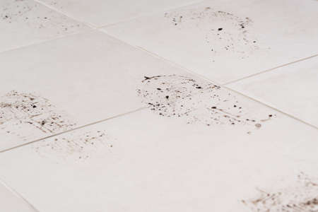 footprints of the sole of shoes on the floor of ceramic tiles, close-up