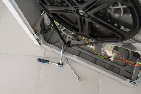 washing machine repair tools laid out in front of the washing machine mechanism, top viewの写真素材