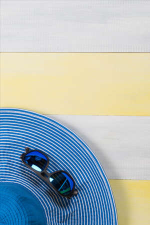 on the gray-yellow surface, a hat and sunglasses, there is a place for the inscriptionの写真素材