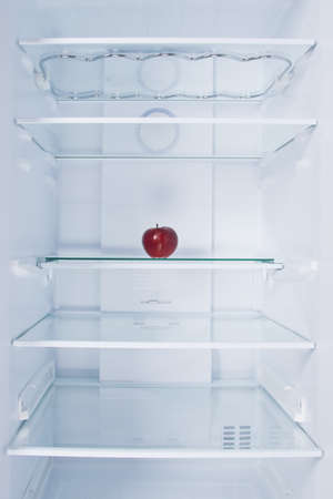 red apple, in the refrigerator, on a glass shelf, on a white backgroundの写真素材