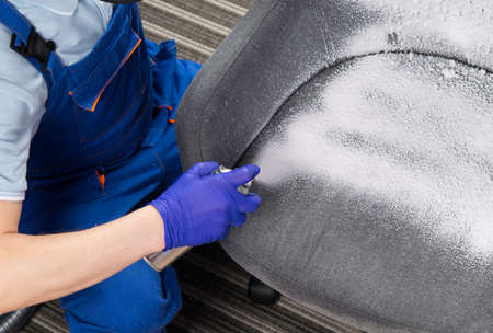 applying cleaning foam from a balloon in your hand, close-upの写真素材