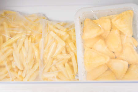 frozen semi-finished products from french fries and dough are in the freezer drawerの写真素材