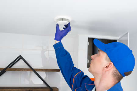a worker adjusts the extractor hood in the bathroomの写真素材
