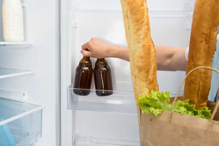 unpacking from packages of food and alcoholic beverages delivered by courier to your homeの写真素材