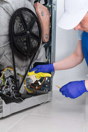 maintenance of washing machine assembly units, by a master in household appliances electronicsの写真素材