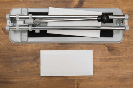 tile cutting tool lies on a wooden backgroundの写真素材