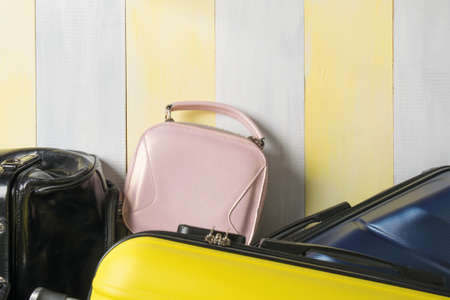 a set of bags and suitcases for women and men on a gray-yellow background, on top of a place for your inscription, close-upの写真素材