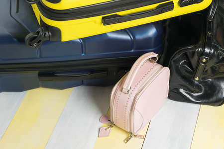 a set of bags and suitcases for women and men on a gray-yellow backgroundの写真素材