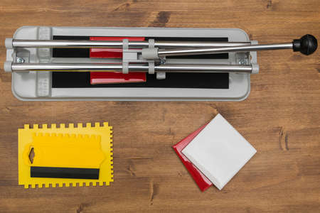 tool for working with wall tiles on a wooden background, top viewの写真素材
