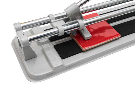 tile cutter and wall red tile isolated on white backgroundの写真素材