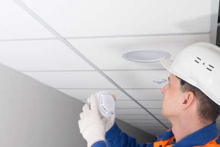 the master of fire alarm maintenance, conducts an inspection in the residential sector, there is a place for the inscriptionの写真素材