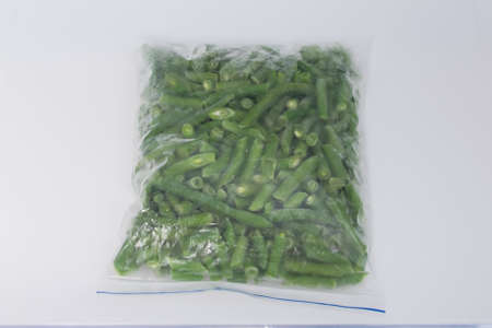 on a white background, close-up, frozen string beans, in a food storage bagの写真素材