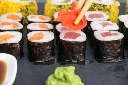 chinese sticks carry ginger on the background of the table with rollsの写真素材