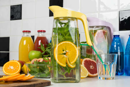 a decanter of refreshing orange lemonade stands on the tableの写真素材