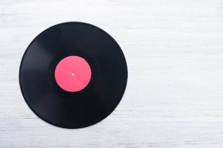 black vinyl record on gray wooden backgroundの写真素材