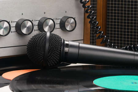 vinyl records and microphone on the background of an old turntableの写真素材