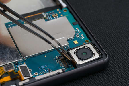 close-up of the installation of a video camera on a smartphone phone, after repairの写真素材