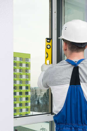 the worker measures the installed window in the houseの写真素材