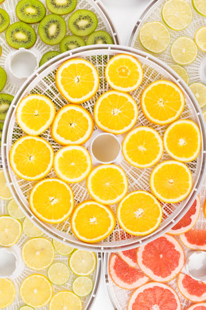 drying trays with fresh fruit wedges, backgroundの写真素材