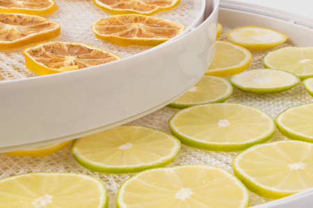 dried and fresh lemon wedges in a drying tray, background close-upの写真素材